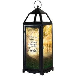 Black lantern with a printed memorial message and forest scene