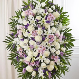 Standing floral spray of white, pink, and purple flowers on an easel