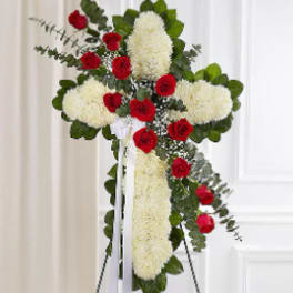 Standing floral cross with red roses and white blooms