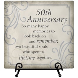Decorative plaque reading "50th Anniversary" on a stand