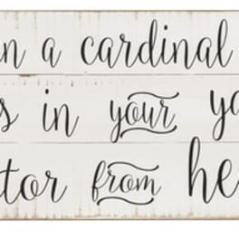 Wooden sign with cardinal illustration and memorial quote