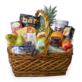 Gift basket with fruit, snacks, and a pineapple centerpiece