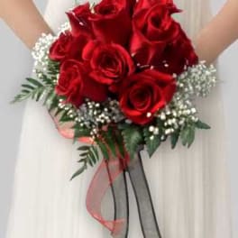 Bridal bouquet of red roses with baby's breath and ribbon streamers