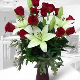 Red roses and white lilies in a tall vase