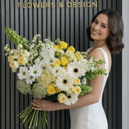 Woman holding a large bouquet of white and yellow flowers