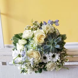White rose bouquet with daisies and a succulent