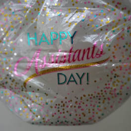 Clear confetti balloon with "Happy Assistant Day" text