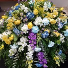 Large mixed floral spray with yellow, white, blue, and purple flowers