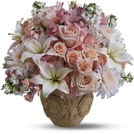 Pink and white floral arrangement in an ornate ceramic vase