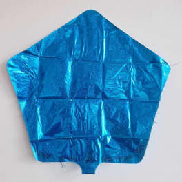Blue metallic pentagon-shaped foil balloon against a white wall