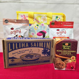 Hawaiian snack gift set with noodle box, cookies, snack bags, and a yellow printed tote.
