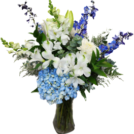 Blue and white floral arrangement in a glass vase