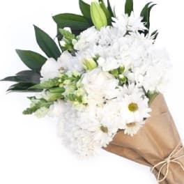 White bouquet with daisies and lilies wrapped in brown paper