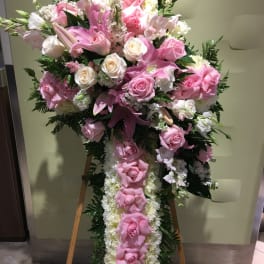 Large pink and white floral standing spray on an easel