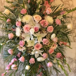 Large pink and white floral standing spray with roses and lilies