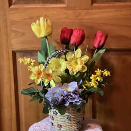 Basket arrangement of colorful tulips and daffodils