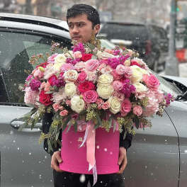 Large pink and white rose arrangement in a pink box