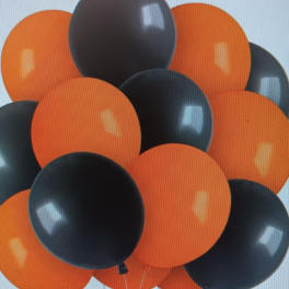 Cluster of orange and black balloons against a light background