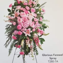 Pink funeral spray on a standing easel with lilies and roses