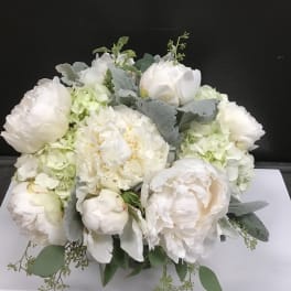 White peonies and hydrangeas arranged in a low bouquet