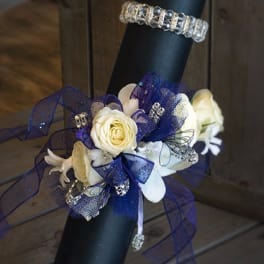 White roses and lilies with blue ribbon on a black handle