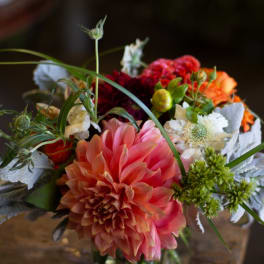 Mixed bouquet with a large pink dahlia in a glass vase