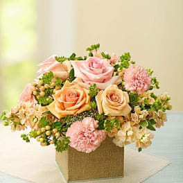 Pink and peach roses with carnations in a square box