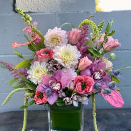 Pink and white mixed bouquet in a square glass vase