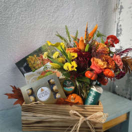Mixed bouquet in a wooden gift box with chocolates and self-care items