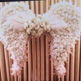 White floral casket spray with roses and cascading blooms