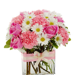 Pink roses and carnations with white daisies in a glass vase