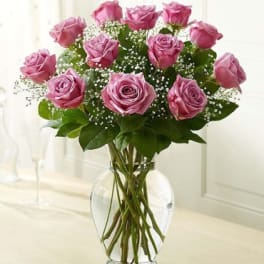 Pink roses arranged in a clear glass vase