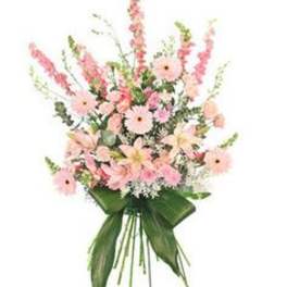 Tall standing spray of pink flowers with large green leaves on a metal easel