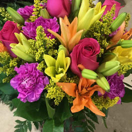 Bouquet of pink roses, lilies, and purple carnations