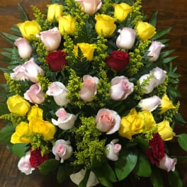 Tiered bouquet of yellow, pink, and red roses with greenery