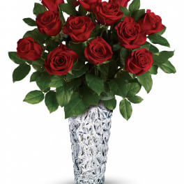 Red roses arranged in a clear textured vase