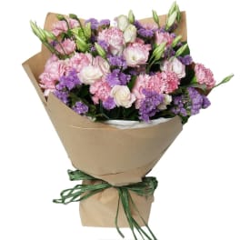 Bouquet of pink and white flowers wrapped in brown paper