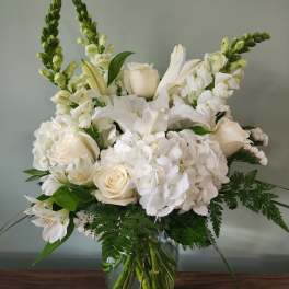 White floral bouquet in a clear glass vase