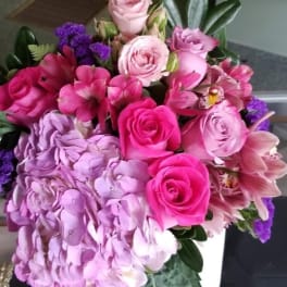 Pink and lavender bouquet with roses, hydrangea, and orchids