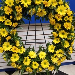 Yellow daisy wreath on a black easel