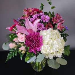 Pink and white mixed bouquet in a clear glass vase