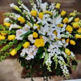 Large white and yellow floral spray with lilies and roses
