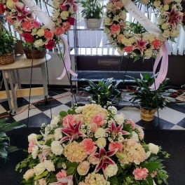 Large floral funeral wreaths and spray with pink and white flowers