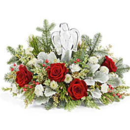 Red roses and white flowers arranged with an angel ornament