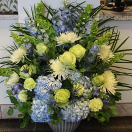 Blue and yellow floral arrangement in a vase