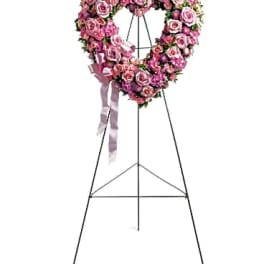Pink rose heart-shaped standing floral wreath on an easel