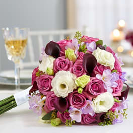 Bouquet of pink and white roses with dark calla lilies
