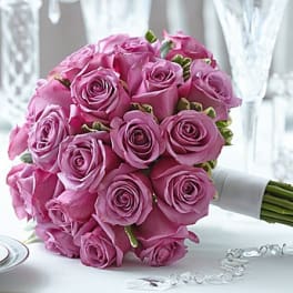 Bouquet of pink roses with a white ribbon wrap
