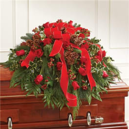 Red rose casket spray with ribbon and pinecones