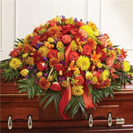 Large red, yellow, and orange floral spray on a casket